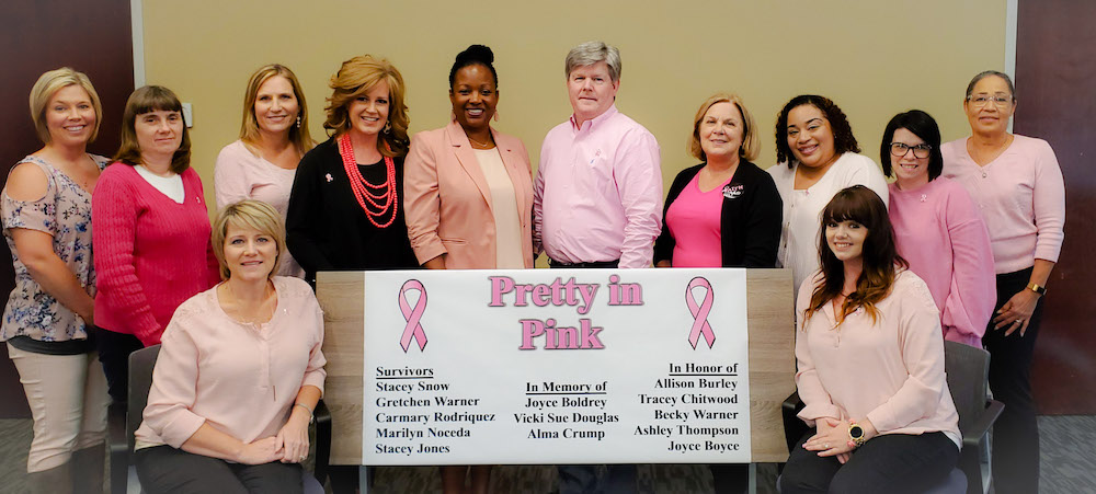 HCWA employees showing their support for the Piedmont Henry Hospital Real Men Wear Pink breast cancer awareness campaign include (Standing, L to R): Shelley Boggess, Cathy Stevens, Lori Gardner, Meredith McClendon, Karen Lake-Thompson, Scott Harrison, who was selected to participate in this year’s campaign, Vicki Mott, Elena Guerrero, Wendy Johnson, and Mimi Reynolds. Seated left is Stacey Snow and seated right is Suzanne Earls. 